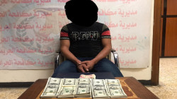 في بغداد .. القبض على تاجر عملة مزيفة بحوزته آلاف الدولارات منها