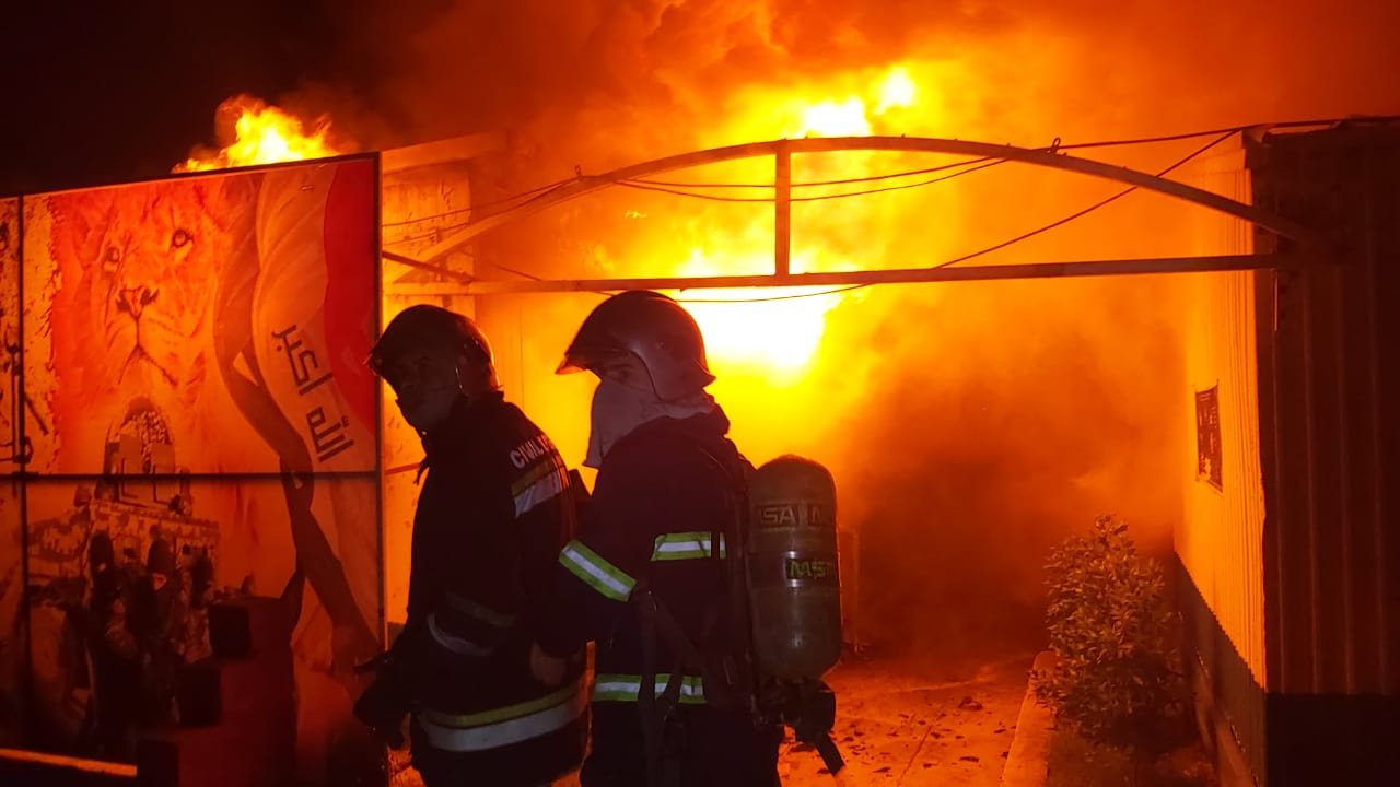Civil defense teams extinguish fires near police equipment warehouse