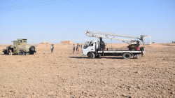 Iraqi army protecting maintenance teams repairing electric power towers northeast of Diyala