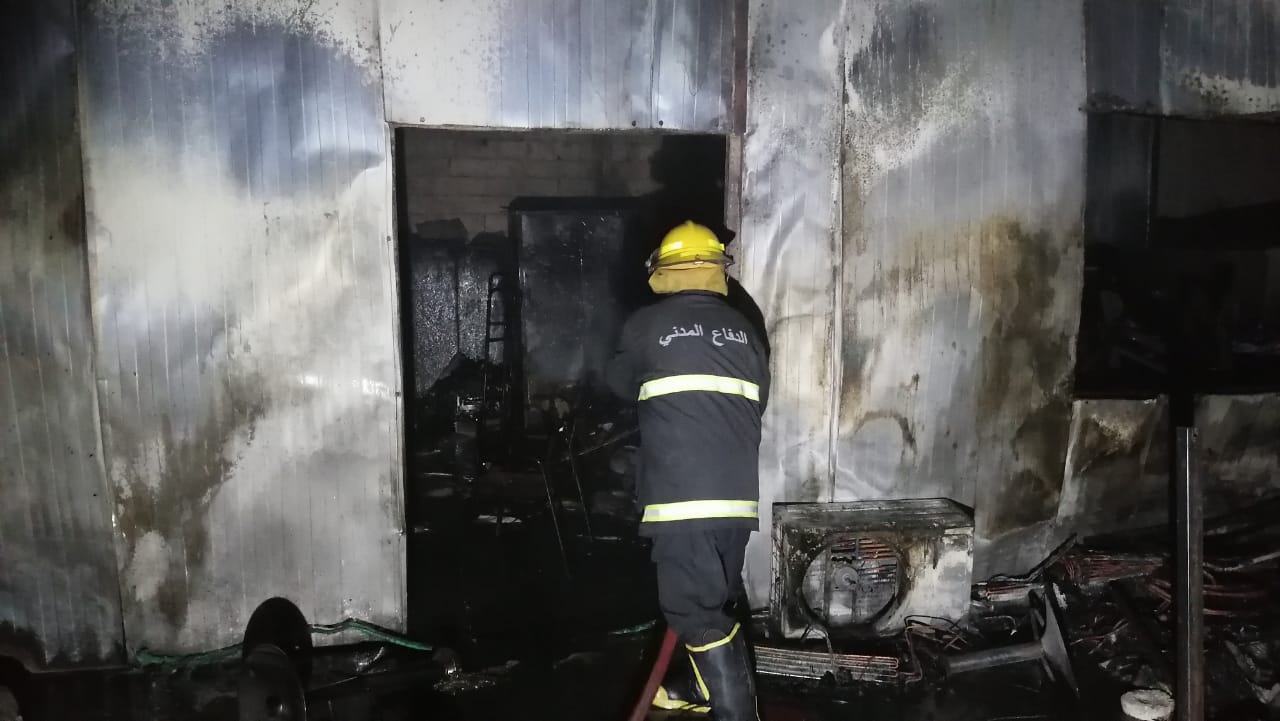 Civil defense teams put out fires that broke out inside a building in Najaf 