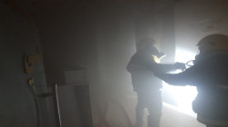 Firefighters extinguish a fire in a hotel in Najaf