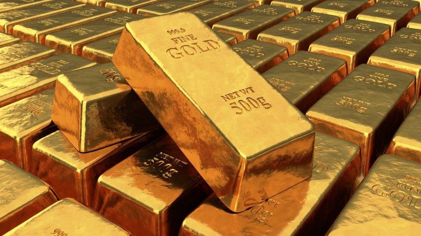 Gold eases on global recovery hopes; weak US dollar limits losses