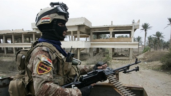 Iraqi security forces defuse an IED on an international road in Southern Iraq