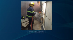 Civil defense teams extinguish a fire in Baghdad