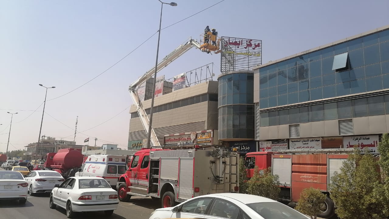 Civil Defense teams extinguish a fire in a medical complex in Najaf