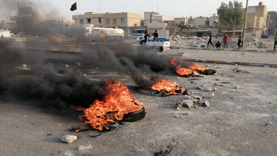 Angry protestors block a main road in Nasiriyah