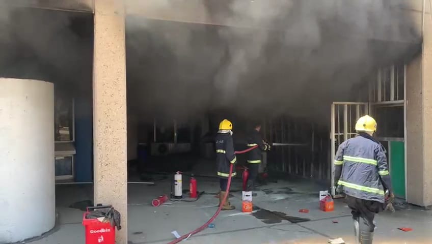 Civil Defense teams extinguish a fire in a library in Baghdad 