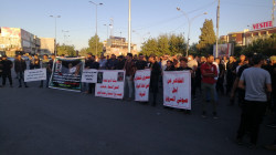 Dozens block a main road in Kirkuk to protest violence against the demonstrators in Baghdad 