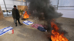 Demonstrators burn the U.S. and Israeli flags outside the Green Zone