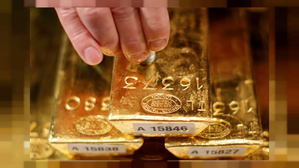 PRECIOUSGold hits month low as dollar strengthens after Powell speech