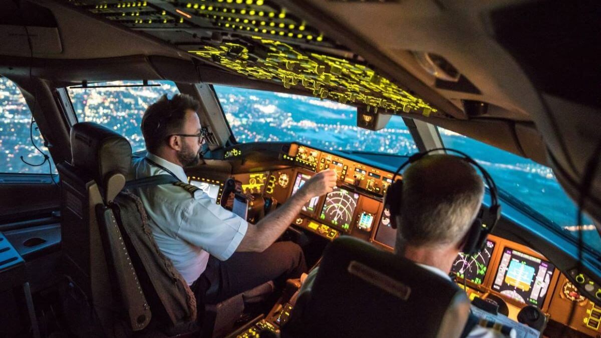 Pilot hangs out of cockpit window to retrieve passenger's phone