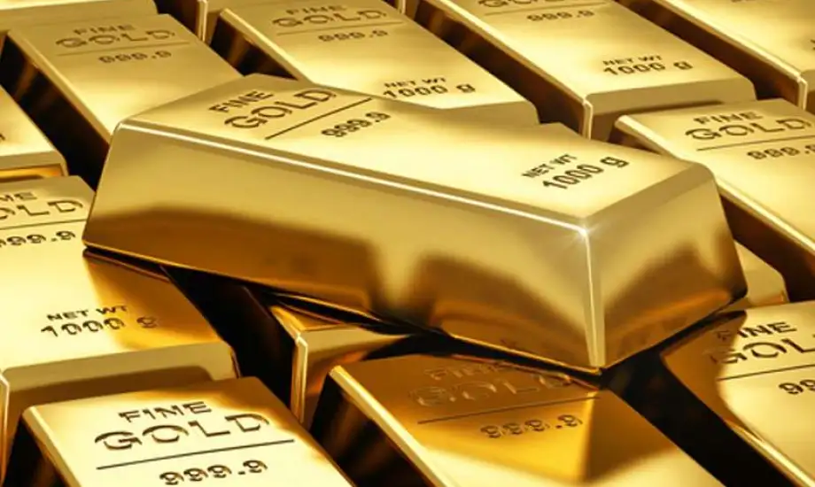 Gold prices inched down, on track for a weekly gain