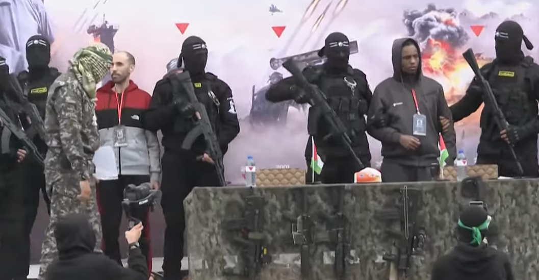 Hamas delivers 2 Israeli hostages to Red Cross amid military display