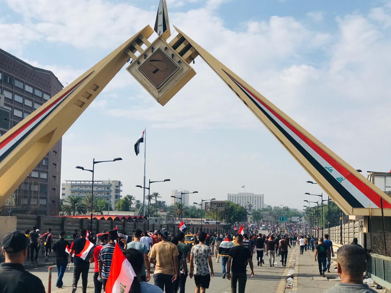 Demonstrators arrive at the gate of the Iraqi parliament