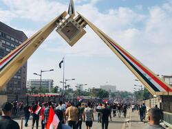 Demonstrators arrive at the gate of the Iraqi parliament