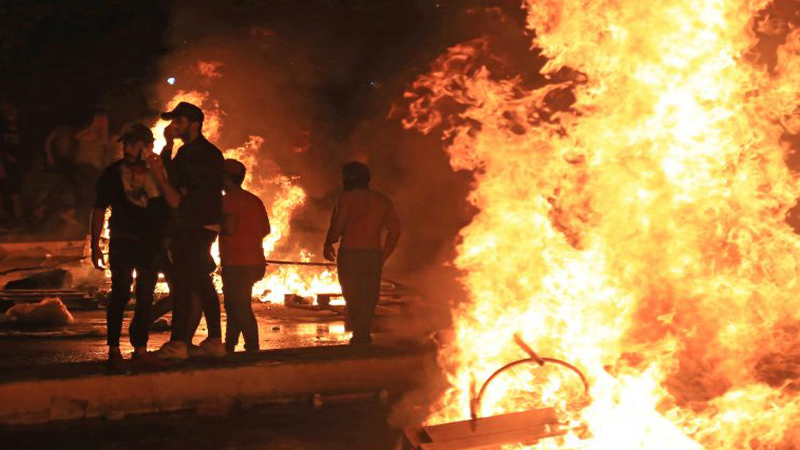 Demonstrators block a main road between two provinces in southern Iraq