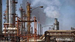 Oil prices inched up as US Crude stocks dropped