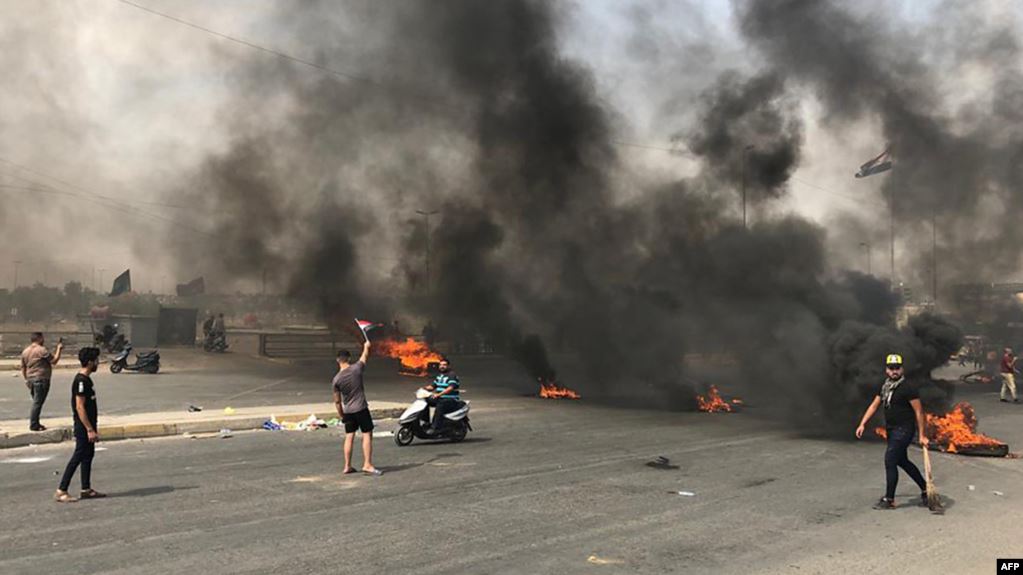 Protesters block roads leading to the center of an Iraqi province