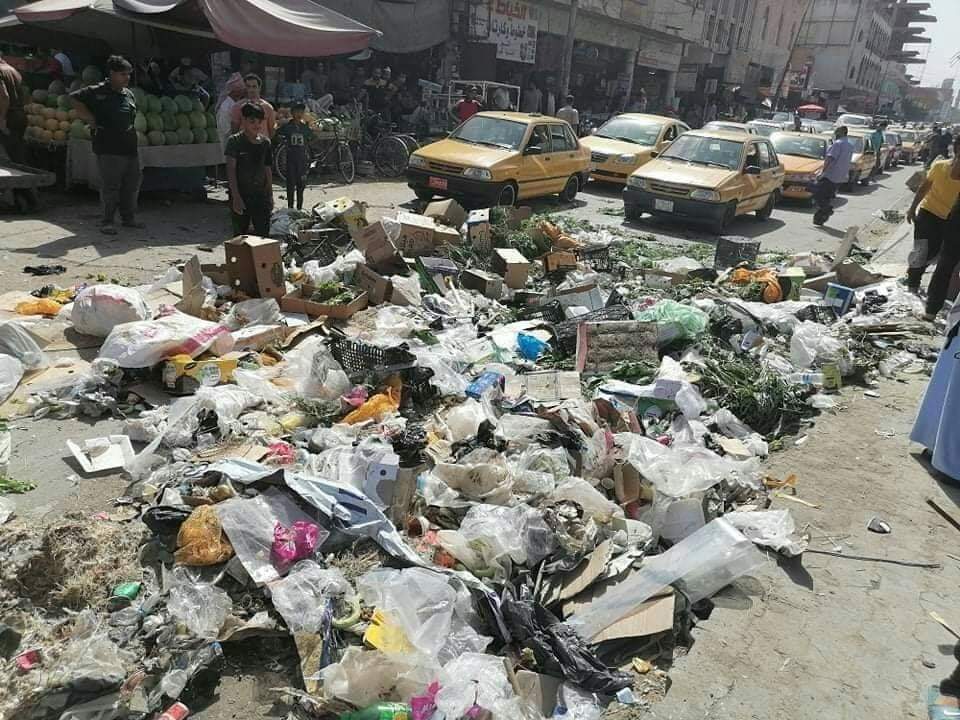 بالصور.. عمال النظافة ينثرون النفايات في شوارع الديوانية بدل جمعها